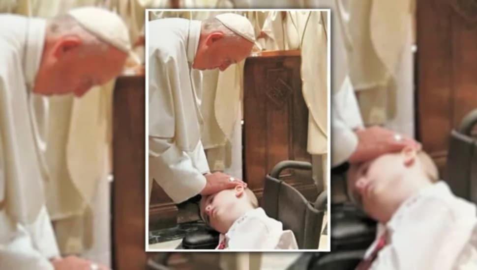 Pope Francis blesses Conall Harvey with his hand on boy's head.
