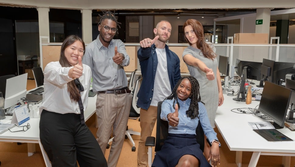 Young professionals looking happy at work.
