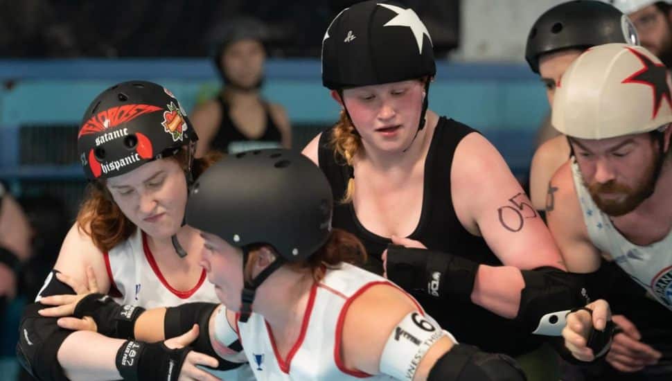 Brandywine Roller Derby players tussling during match.