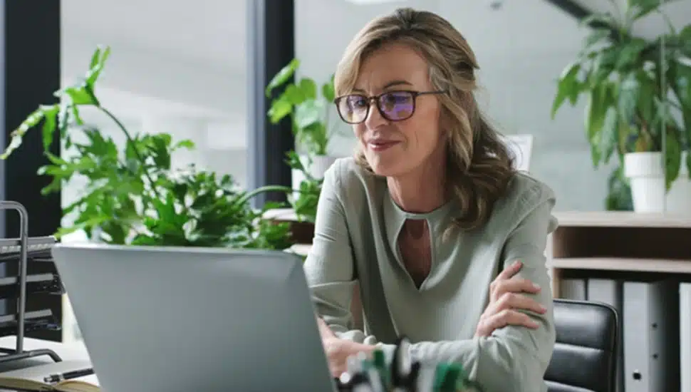 Female business owner works on her laptop computer.