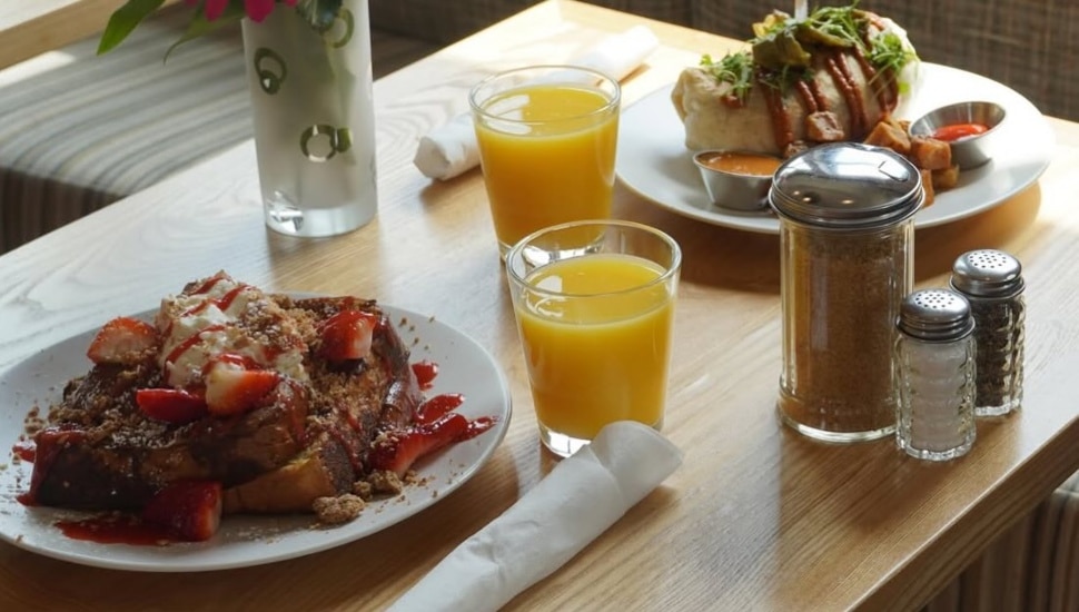 Plates of food, drinks, and condiments on table at Cafe Lift.