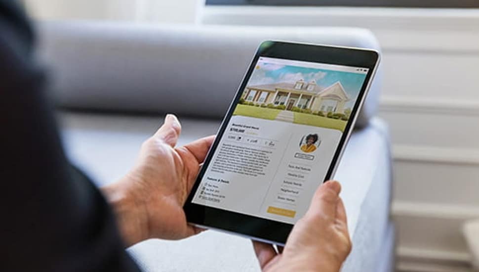 Person shops for a home on an iPad.