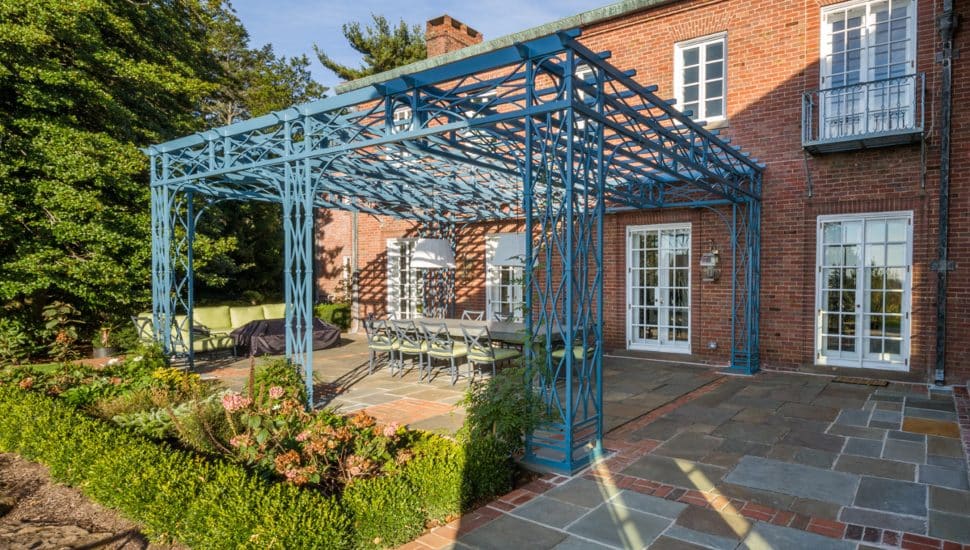 Blue iron pergola made by Compass Ironworks.