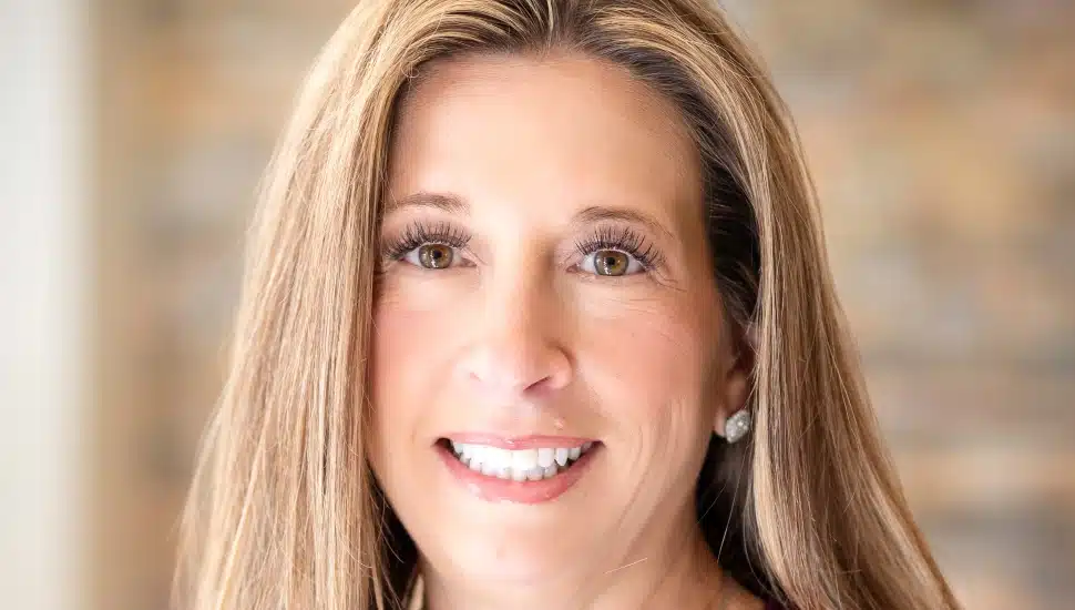 Headshot of middle-aged female bank executive with brown hair.