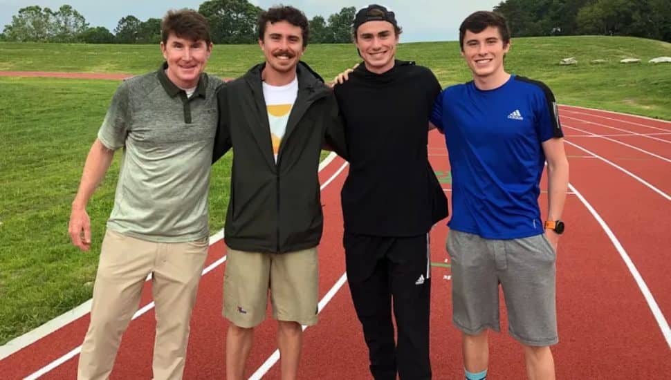 Josh Hoey with his brothers and dad on track in backyard.
