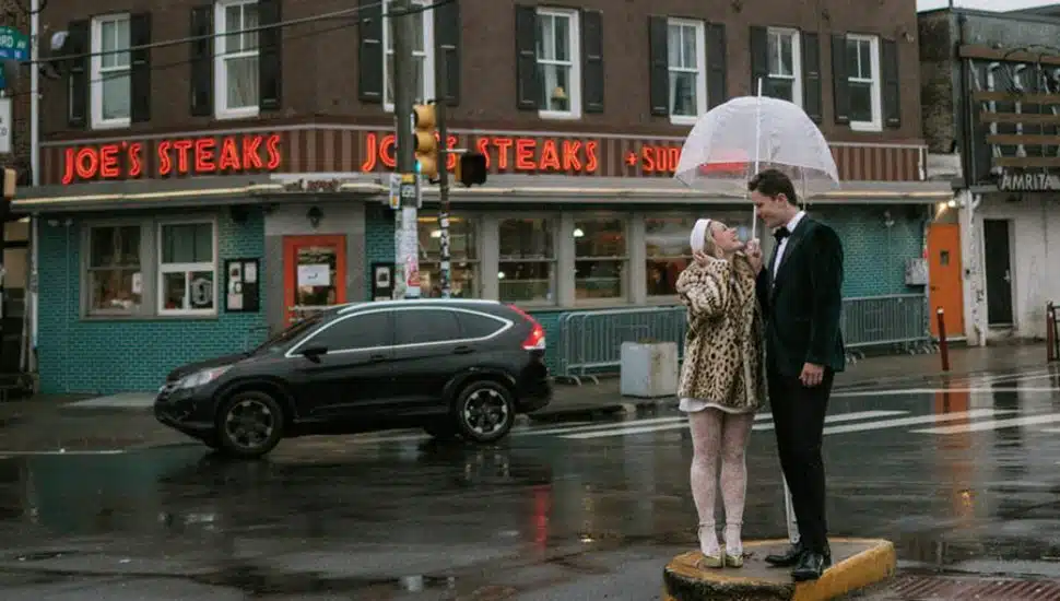 Justin and Lainey on a street in the rain.