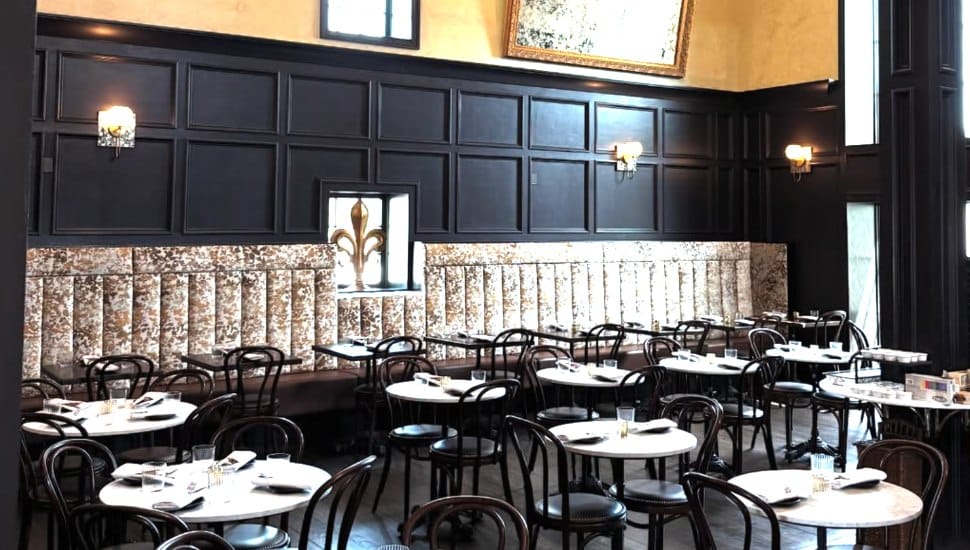 La Grange dark interior with dozens of small tables for European atmosphere.