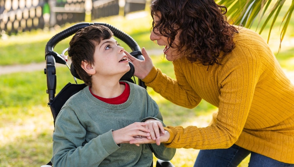 Loving mother supporting her son with disability.