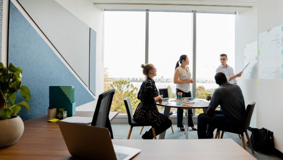 Workers discuss strategy in a conference room.