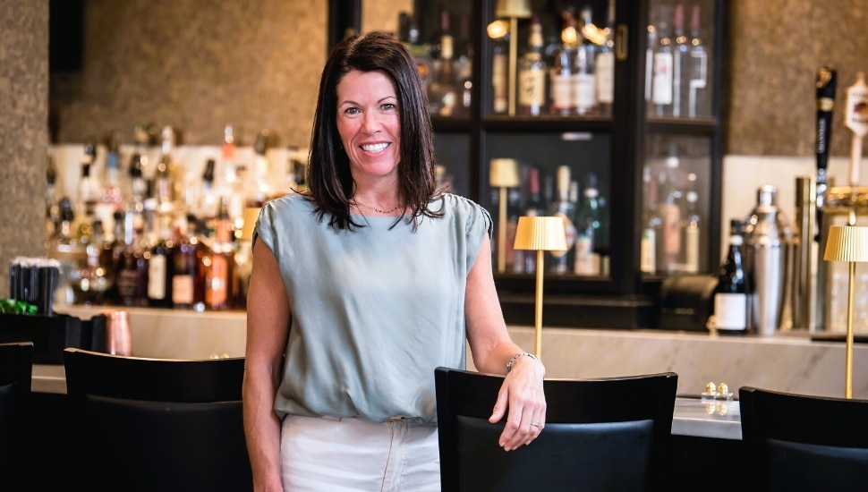 Roxanne Fitzgerald with bar in background.