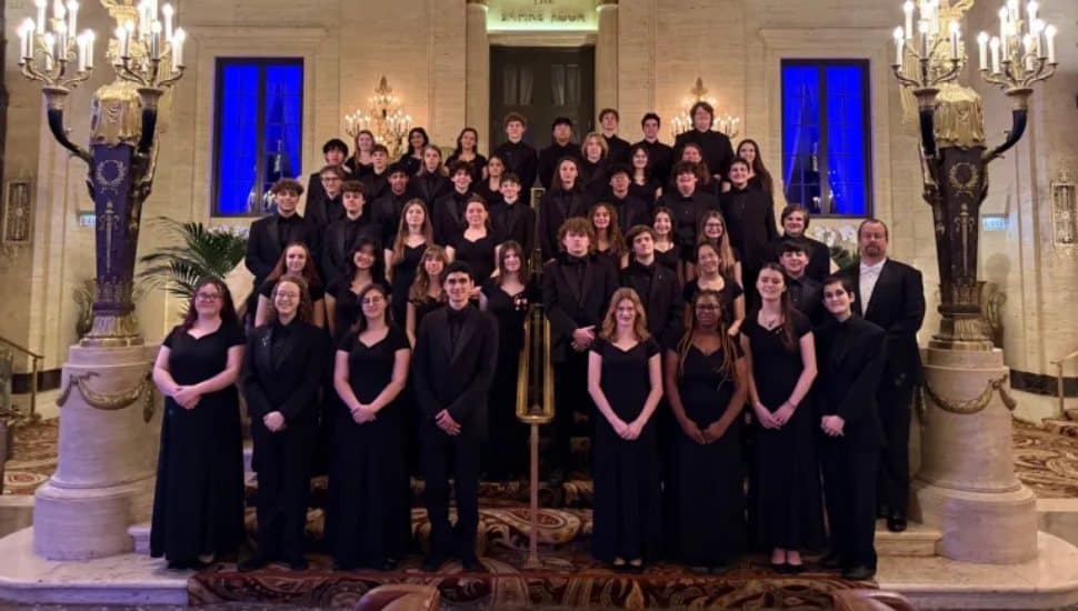 Rustin High School Band students on stairs dressed in all black.
