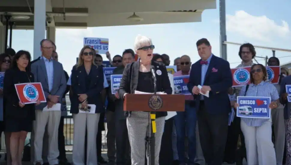 Sen. Carolyn Comitta speaks at SEPTA press conference with group behind her.