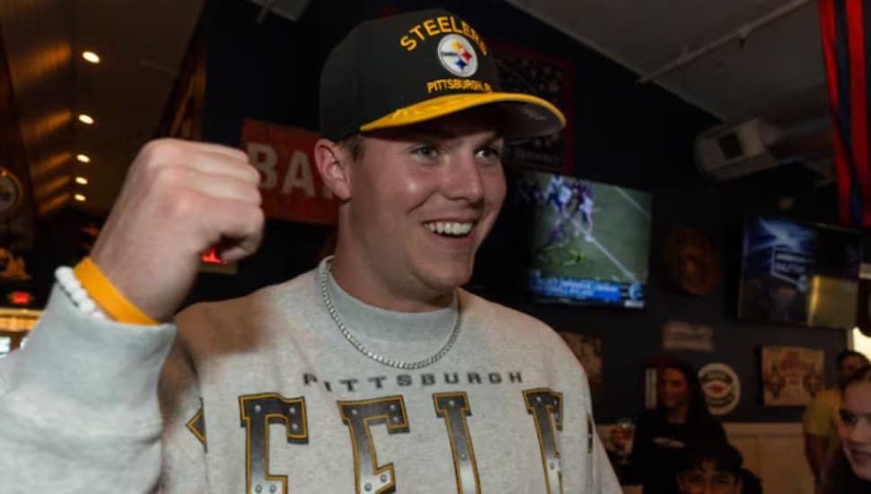 Will Howard with his fist in the air and Steelers hat on after being drafted.