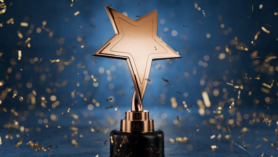 Gold star on a blue background as a reward. Top Performance Award. Winners Cup. Achievements. Victory. Goal achievement concept. Winner certificate.