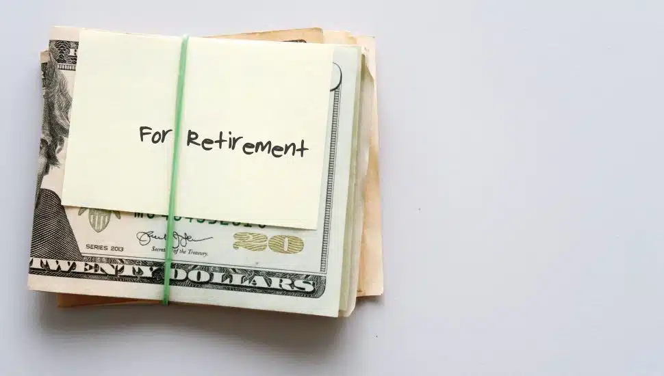 Dollars wrapped in a note that says "for retirement."