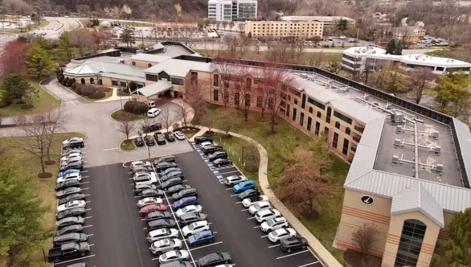 Desmond Hotel Malvern aerial view with building and parking lot full of cars.