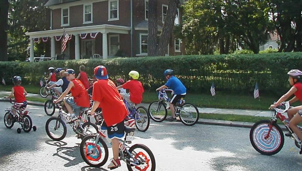 Kids riding bikes down the street.