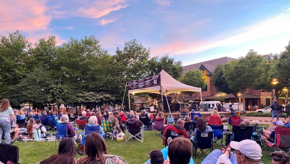 A music performance and surrounding crowd at Eagleview Town Center.