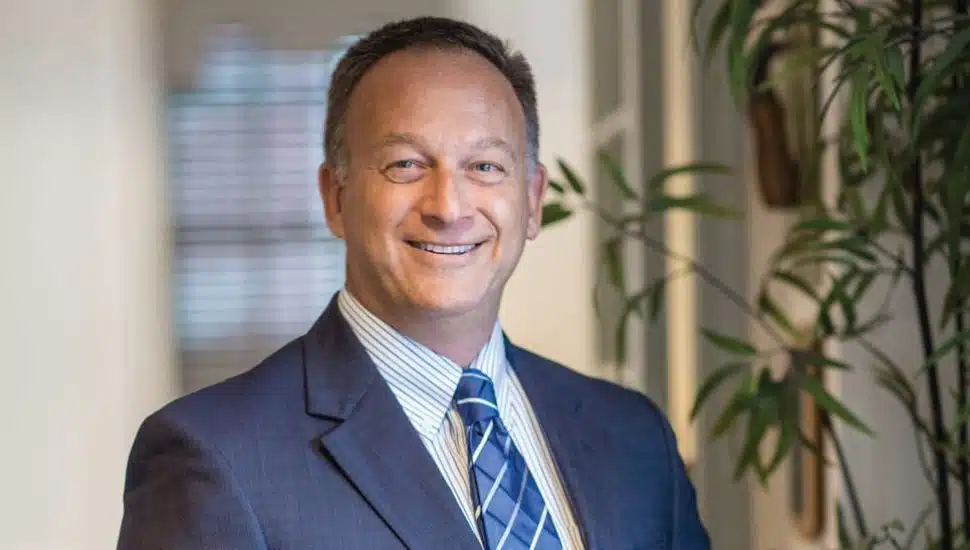 Joel Frank in a suit headshot.