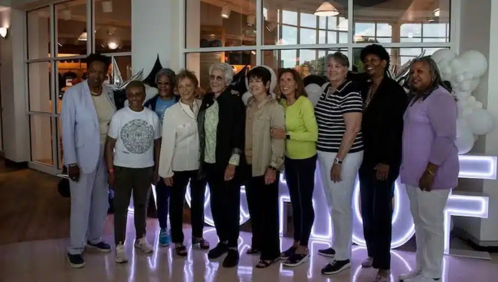 Lucille Kyvallos and other inductees lined in a row smiling.