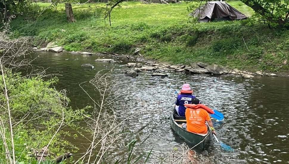 Two canoe-riders on the Brandywine River with Northbrook Canoe Company.