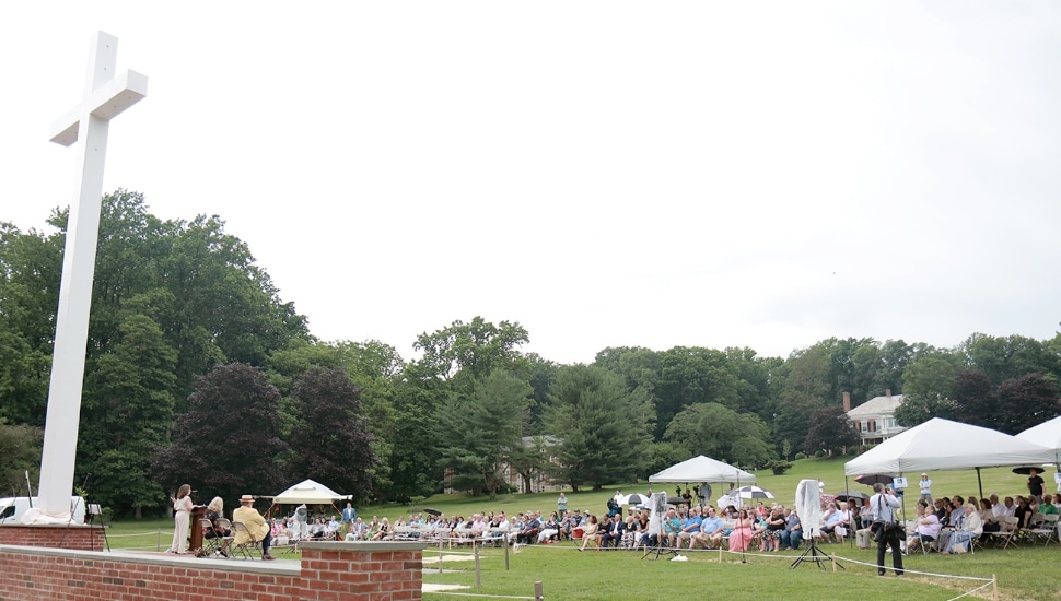 A crowd gathered in front of the 40-foot papal cross now located at Malvern Retreat House.