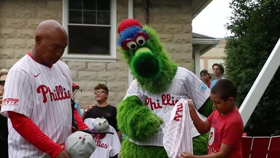The Phillie Phanatic with members of the Almada Family in the family's renovated backyard.