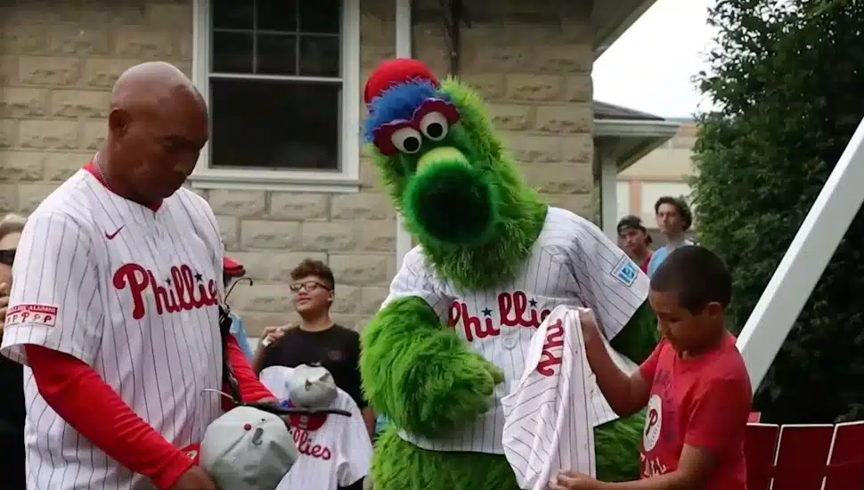 The Phillie Phanatic with members of the Almada Family in the family's renovated backyard.
