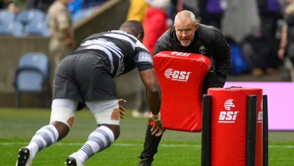 Richie Gray practices with rugby player.