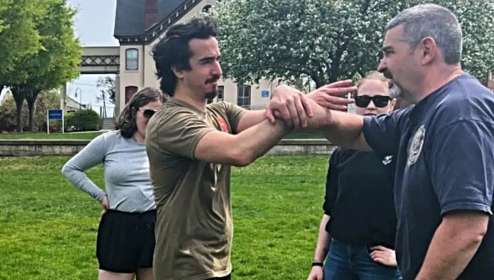 Self-defense instructors Sam Flood and Rob Kloss, co-owner of Cornerstone Martial Arts in Hockessin, Delaware. demonstrate a self-defense technique for Widener students.