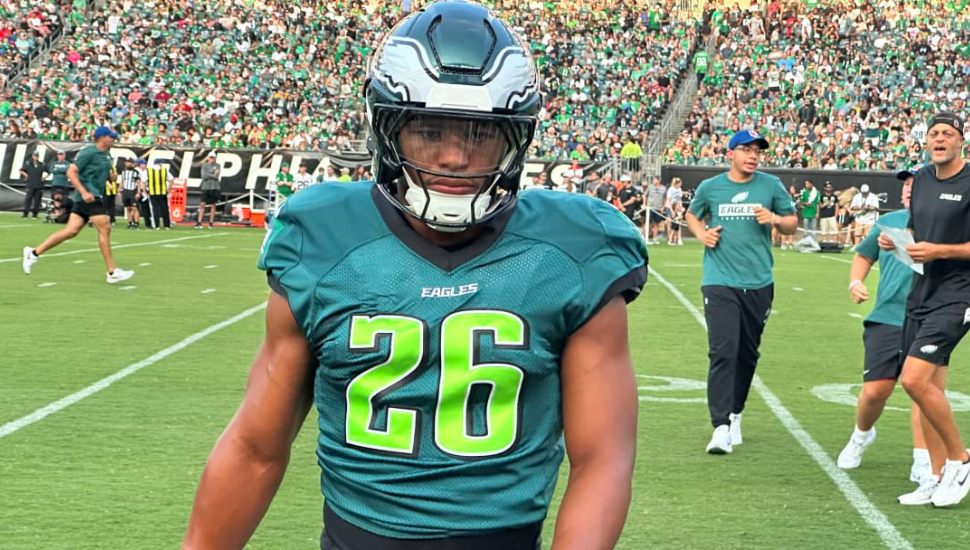 Saquon Barkley in two tone green Eagles uniform on field.