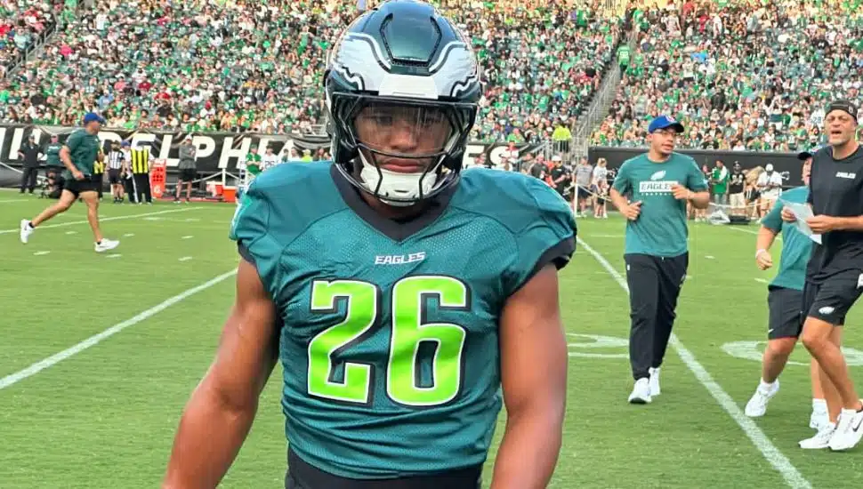 Saquon Barkley in two tone green Eagles uniform on field.