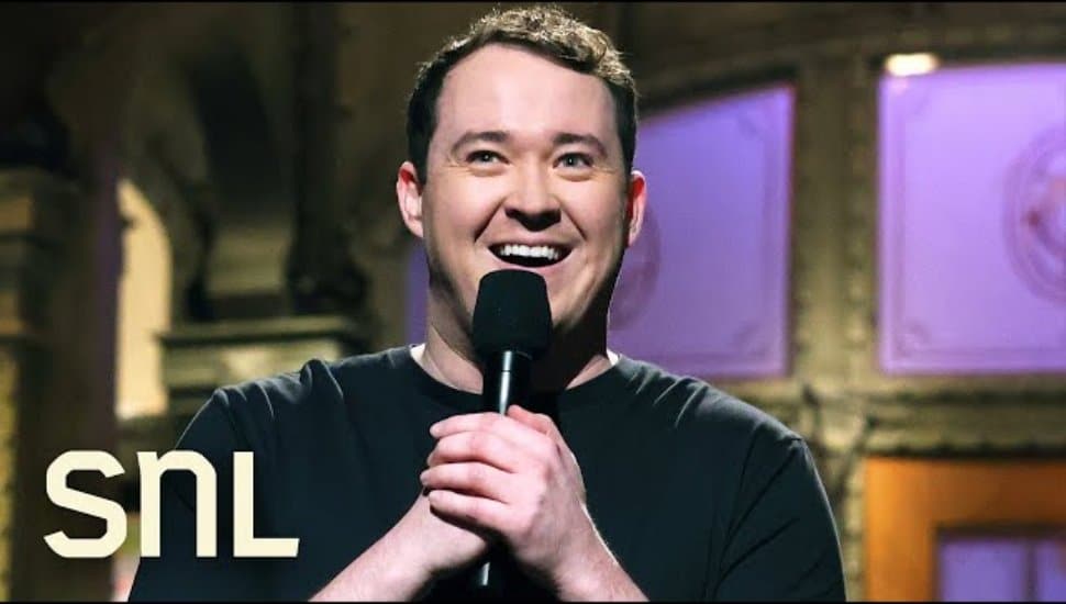Shane Gillis holding a microphone on SNL.