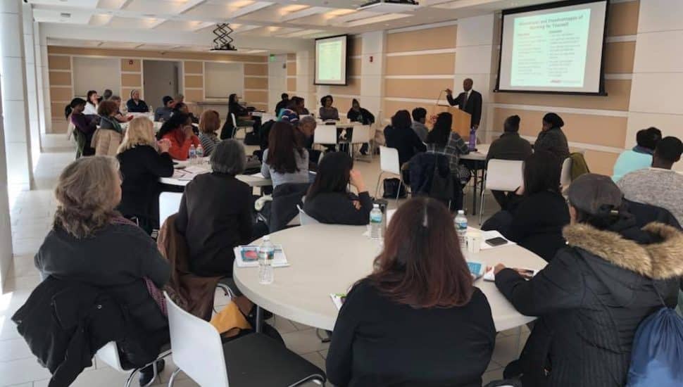 Women gathered for business conference presentation.