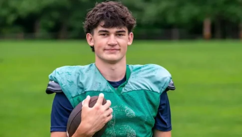 Xavier Stearn holding a football on the field.