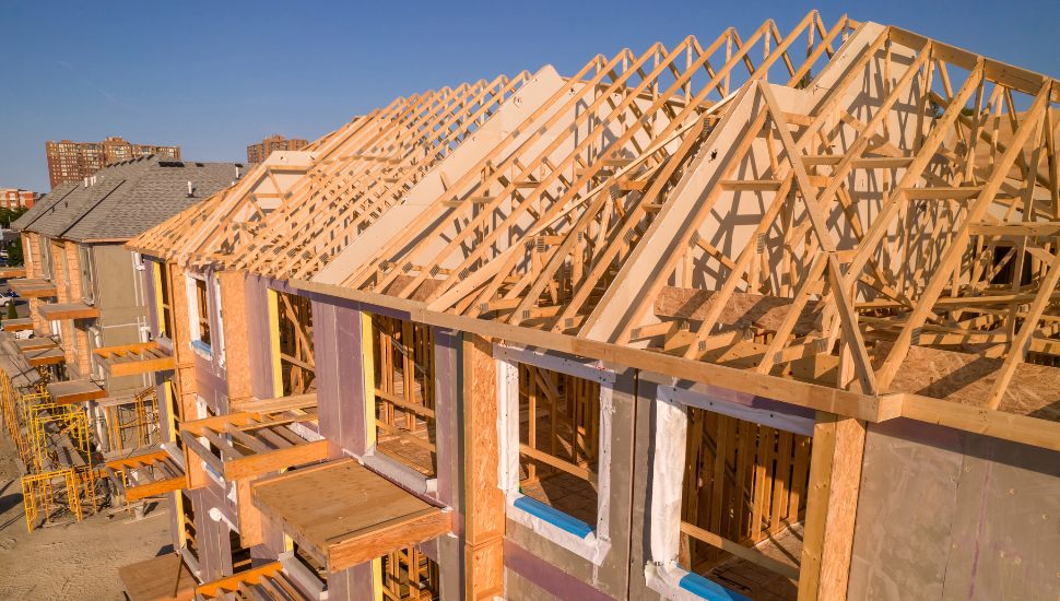 Wooden structures of houses being built.