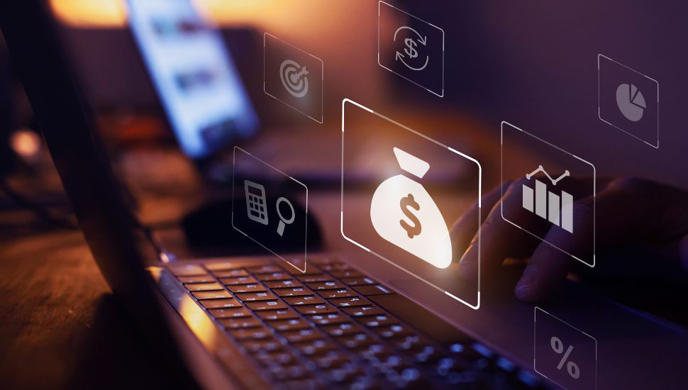 Investment and finance concepts around a laptop.