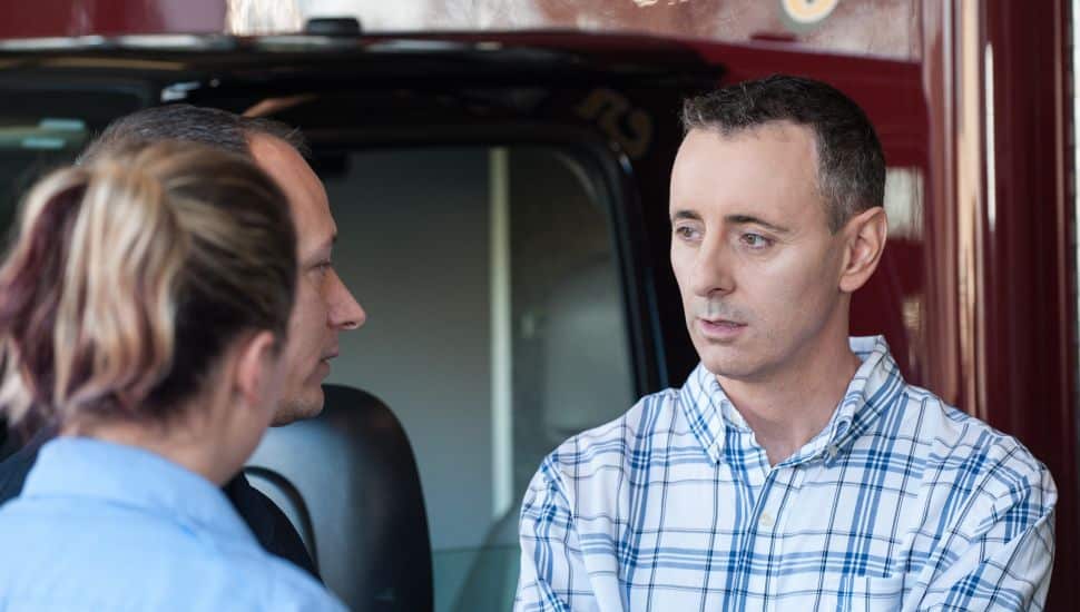 Brian Fitzpatrick, right, talking to people.