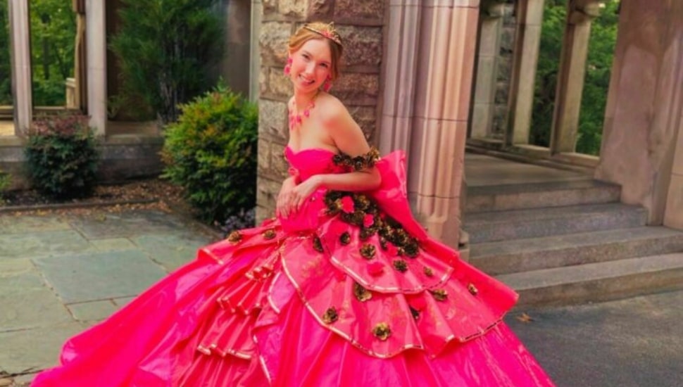 Teen Emmalyn Holland wearing her bright pink prom dress made out of duct tape.