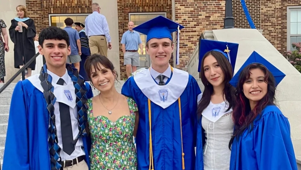 Kennett High School after-school program director Loretta Perna with graduating students.