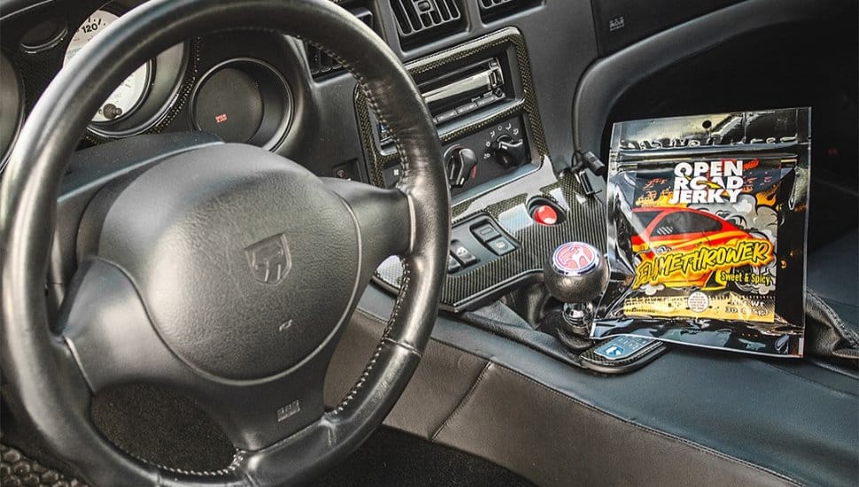 Open Road Jerky pack inside car at radio.