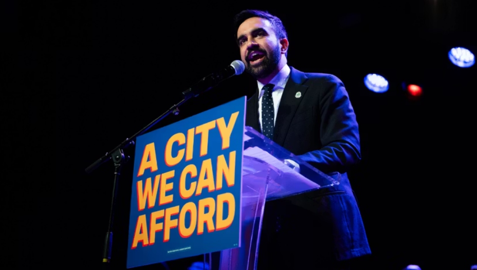 New York City mayoral candidate Zohran Mamdani at podium.