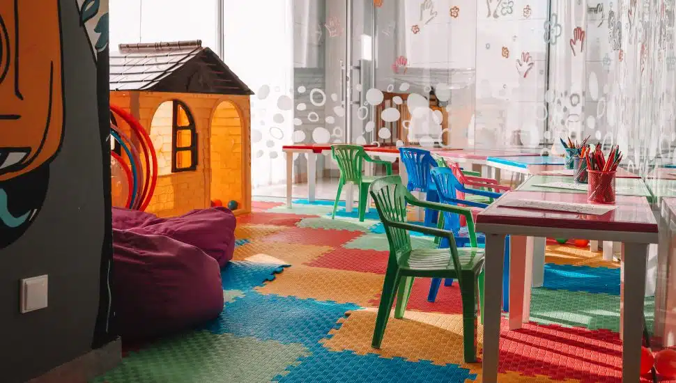 Chairs, table and toys. Interior of kindergarten. Kids play room.