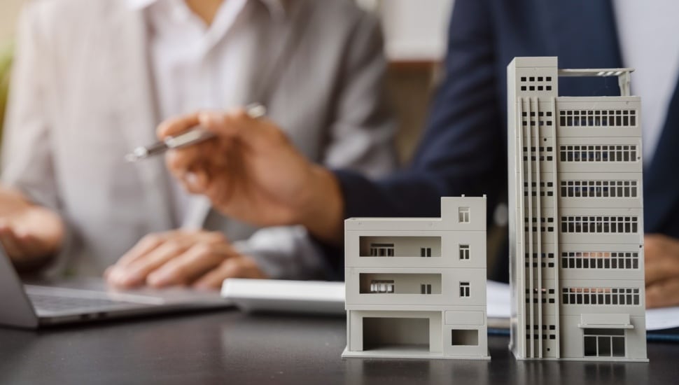 House model with agent asking costumer for contract to buy, get insurance or loan real estate or property.