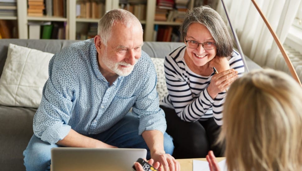 An older couple talks about finances with a consultant.