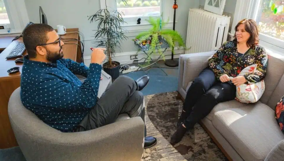 A counselor speaks with a client in the office.