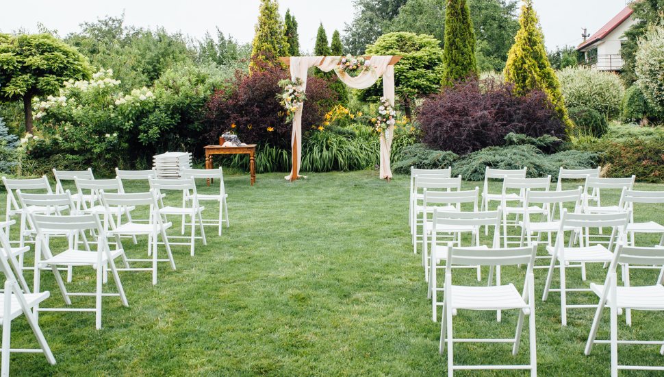 Chairs and an archway at an at-home estate wedding.
