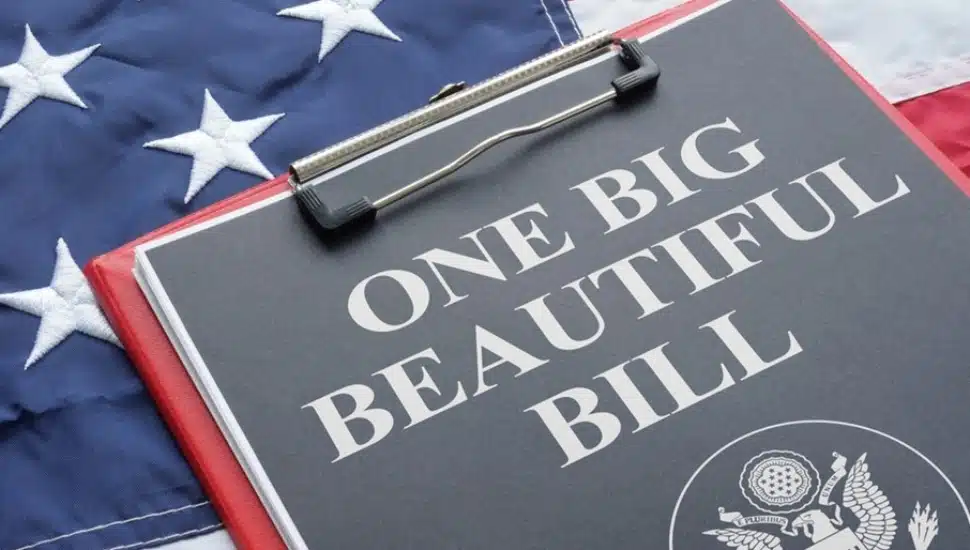 Clipboard that says One Big Beautiful Bill Act on top of American flag.