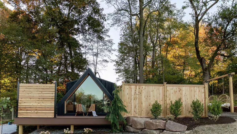 The exterior of a Narvon Airbnb surrounded by green forest.