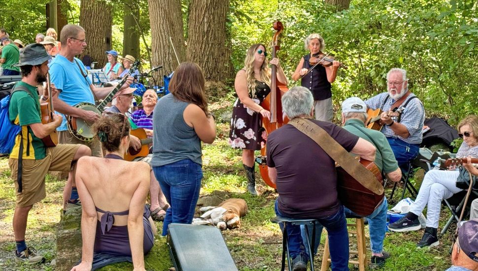 People playing and listening to music at Old Fiddler’s Picnic.